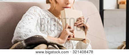 Cropped View Of Woman In White Sweater Holding Book