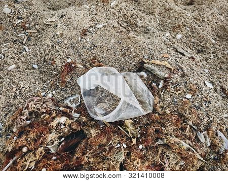 Single Use Plastic Cup In Sand, Marine Trash On The Beach.plastic Pollution On The Beach.  Stop Plas