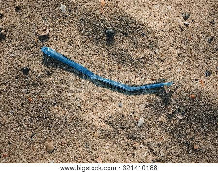 Single Use Plastic Straw In Sand, Marine Trash On The Beach.plastic Pollution On The Beach. Stop Pla