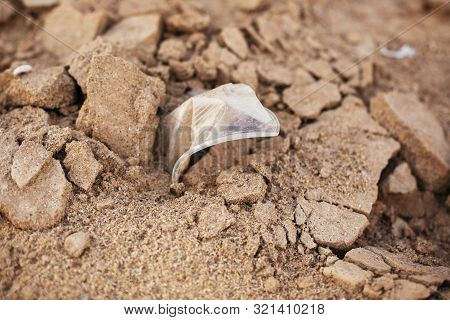 Single Use Plastic Cup In Sand, Marine Trash On The Beach. Plastic Pollution On The Beach.  Stop Pla