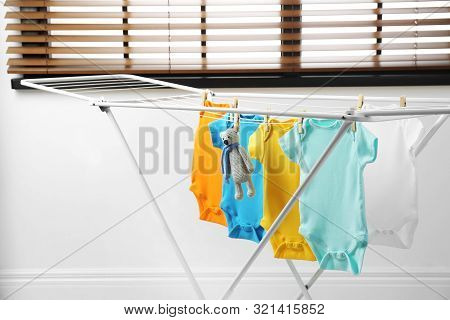 Different Cute Baby Onesies And Toy Bear Hanging On Clothes Line. Laundry Day