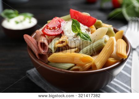 Delicious Vegetable Pasta With Sour Cream Dressing On Black Wooden Table, Closeup
