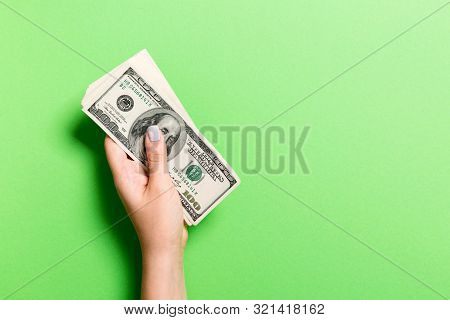 Pack Of One Hundred Dollar Bills In Femle Hands With Copy Space. Top View Of Money Saving Concept On