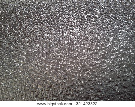 Corrugated Glass On A Gray Background With Play Of Light And Shadow