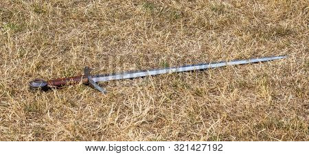 Fighting Sword Lies On Dry Grass. Cold Weapons
