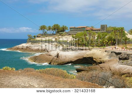 View Of The Rocky Coast And The Famous Casa Del Duque On Cliff In Playa Del Duque Area In Popular Re