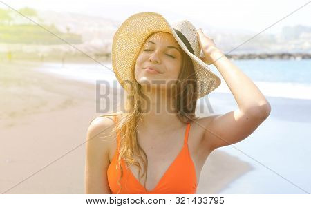 Young Cheerful Bikini Woman With Hat Enjoying Sun On Tropical Beach. Relaxing Sunbathing Holidays In