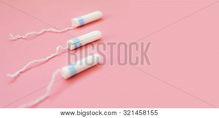 Menstrual Tampon On A Pink Background. Menstruation Time. Hygiene And Protection For Woman
