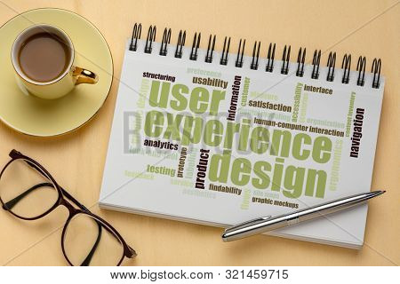 user experience design concept - word cloud in a spiral sketchbook with a cup of coffee
