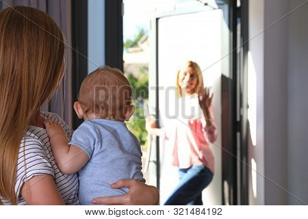 Mother Leaving Her Baby With Teen Nanny At Home. Space For Text