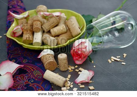 Wine Corks And Empty Glass On Concrete Table.