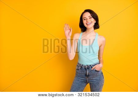 Photo Of Cute Nice Charming Beautiful Careless Girl Saying Hi To You While Isolated Over Vivid Yello