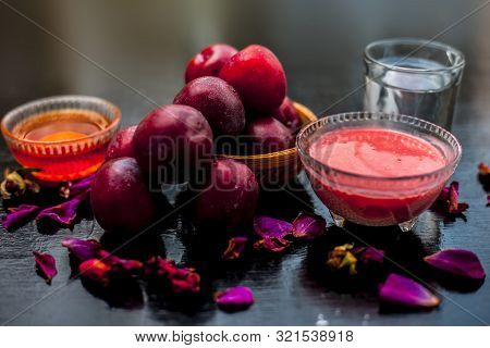 Plum Pulp Well Mixed With Water & Honey In A Glass Bowl Along With Raw Plums Or Prunes Or Aloo Bukha