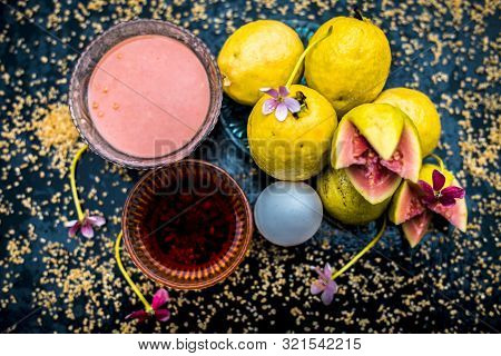 Treatment Of Dry Skin With The Help Of Face Mask On A Wooden Surface Consisting Of Honey, Guava Pulp