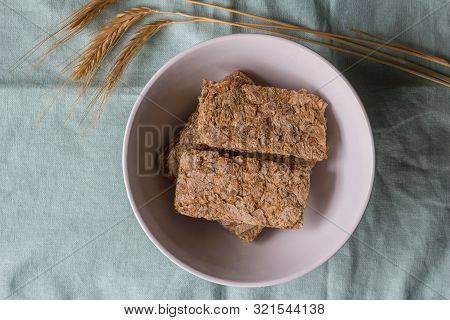 Cereal Bars In Breakfast Bowl With Wheat Ears Next To It - Top View Photo