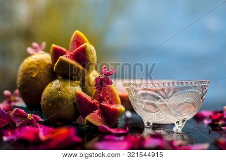 Guava Face Mask For Glowing Skin On A Wooden Surface With A Blurred Background Consisting Of Some Gu