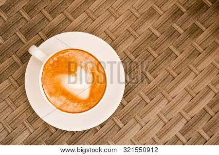 Heart Made Of Cappuccino Foam In White Cup On Wood Table At Cafe. Top View. Place For Text. Bewerage