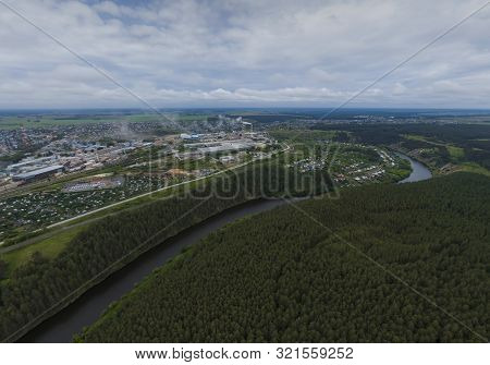 Sukhoy Log City, Pyshma River, Dark Forest And Cement Factory. Russia, Aerial, Cloudu Day
