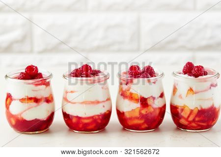 Homemade peach and raspberry dessert with yogurt cream