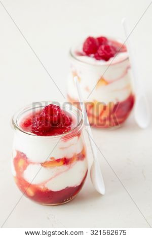 Homemade peach and raspberry dessert with yogurt cream