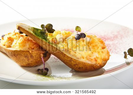Pear baked with cheese isolated on white background, gourmet restaurant dessert. Roasted halves of pears, cheesy delicious fruit autumn dish closeup