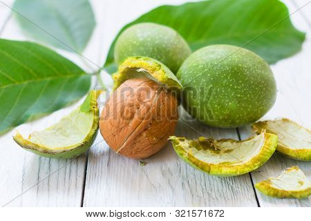 Inshell Walnuts On A White Wooden Table. The Concept Of A Healthy Diet. Close-up.