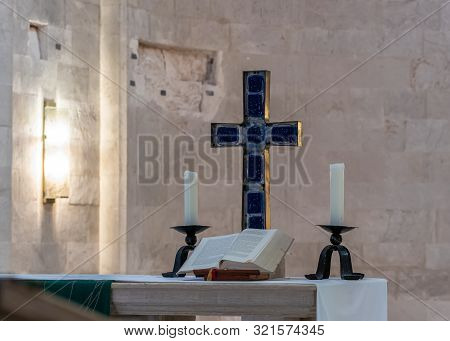 Jerusalem, Israel, September 07, 2019 : Cross, Candles And Scripture On The Table In The Lutheran Ch