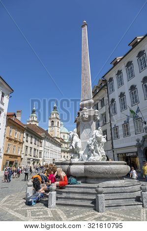 Ljubljana, Slovenia - August 15, 2019: Young People With A Guitar Relax On The Steps Of The Fountain