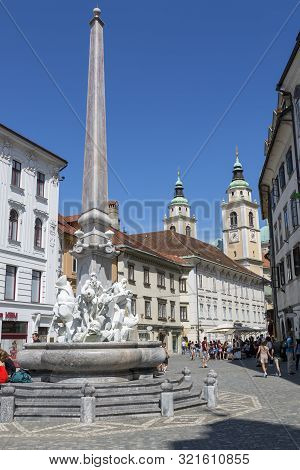 Ljubljana, Slovenia - August 15, 2019: Young People With A Guitar Relax On The Steps Of The Fountain
