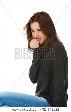 Woman is biting her nails because of stress. Bad habits and dermatology problem.