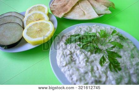 Famous Traditional Arabic Cuisine - Dip Baba Ganoush With Pita Bread And Fresh Lemon On Green Backgr