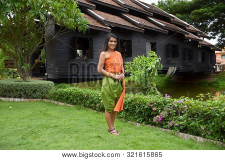 Kanchanaburi, Thailand, 09.09.2019: Beautiful Thai Girl In Traditional Thai, Siamese Dress With Gree