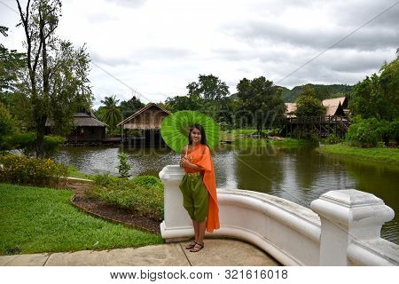 Kanchanaburi, Thailand, 09.09.2019: Beautiful Thai Girl In Traditional Thai, Siamese Dress With Gree