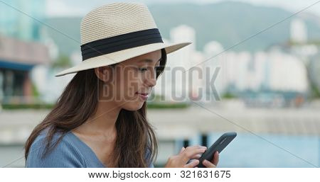 Travel woman use of mobile phone for checking the locatio