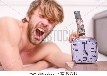 Man Bearded Annoyed Sleepy Face Lay Pillow Near Alarm Clock. Break Discipline Regime. Stop Ringing. 