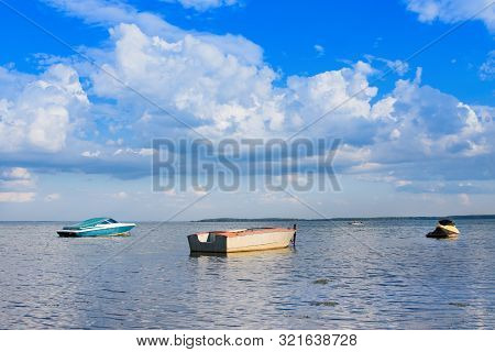 Summer Lake And Boats. Dramatic Sky With Clouds