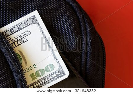 A Thief Unbuttoned Bag From Which A Banknote And A Smartphone Peek Out. Social Issues And Crime. Clo