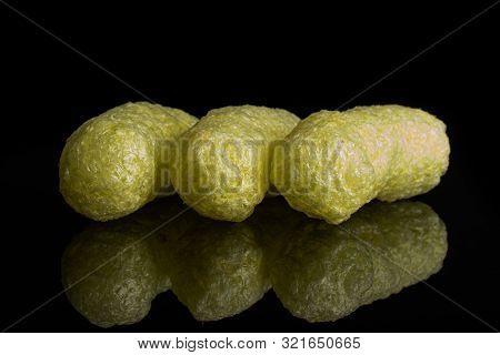 Group Of Three Whole Salted Yellow Corn Puff Isolated On Black Glass