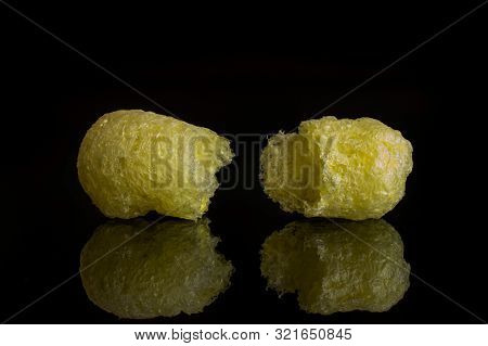 Group Of Two Halves Of Salted Yellow Corn Puff Isolated On Black Glass