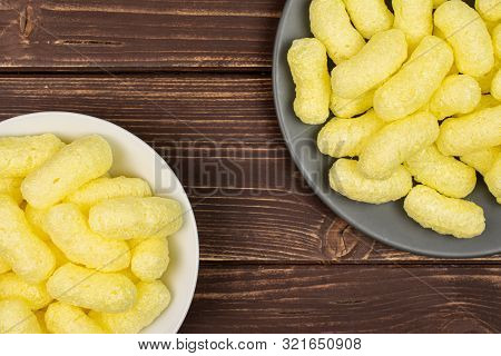 Lot Of Whole Salted Yellow Corn Puff On White Ceramic Plate On Gray Ceramic Plate Flatlay On Brown W