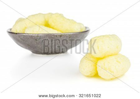 Lot Of Whole Salted Yellow Corn Puff Three Are Aside And The Rest Is In Dark Ceramic Bowl Isolated O