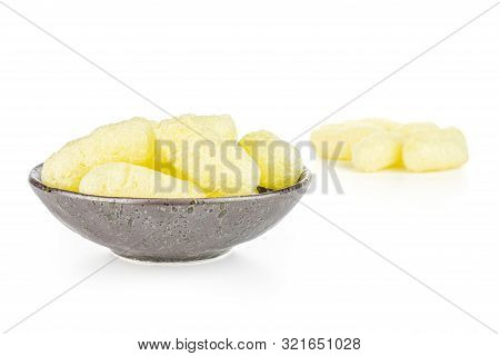 Lot Of Whole Salted Yellow Corn Puff In Dark Ceramic Bowl Isolated On White Background