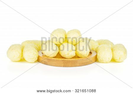 Lot Of Whole Salted Yellow Corn Puff On Bamboo Coaster Isolated On White Background