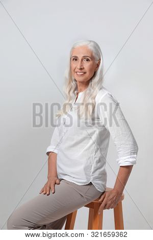 Portrait Of Beautiful Mature Woman On Light Background