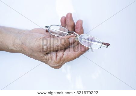 Old Woman Hand Hold  Longsighted Eye Glasses Isolated On White Background