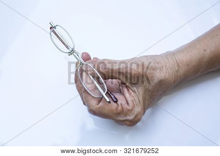 Old Woman Hand Hold  Longsighted Eye Glasses   Isolated On White Background