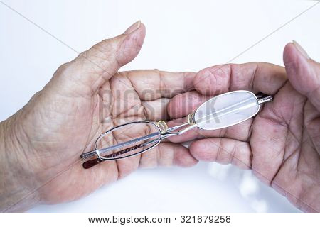 Old Woman Hands Hold  Longsighted Eye Glasses   Isolated On White Background