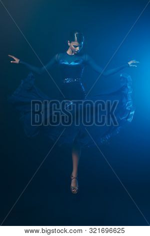 Beautiful girl performs Latino dance with expression. Professional dancer in motion. Beauty, fashion.