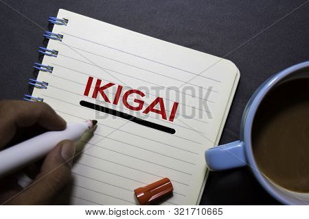 Ikigai Text On The Book Isolated On Office Desk Background. Japanese Concept