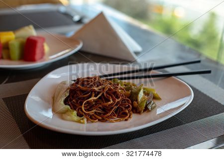 Chinese Fried Noodles And Chopsticks. Side Dish Of Celery And Carrots. Chinese Cabbage. Brown Chines